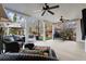 Inviting covered patio space with comfortable seating, ceiling fans and a serene view of the landscaped backyard at 6170 Wellington Ct, Cumming, GA 30040