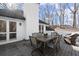 View of deck with a table set, comfortable outdoor seating, and doors that lead to the home's interior at 6170 Wellington Ct, Cumming, GA 30040