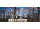 A well-kept single-Gathering home with a dark roof stands out in the sunset, framed by bare winter trees at 6170 Wellington Ct, Cumming, GA 30040