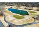 Scenic golf course view with a pond and fountain surrounded by pristine greenery and sand traps at 6170 Wellington Ct, Cumming, GA 30040