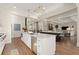 Open-concept kitchen with white cabinets, a large island, and a seamless flow into the living space at 6170 Wellington Ct, Cumming, GA 30040