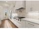 Bright kitchen offers white cabinets, subway tile backsplash, stainless steel appliances, and stone countertops at 6170 Wellington Ct, Cumming, GA 30040
