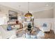 Bright living room with hardwood floors, stylish seating and a view to the kitchen in an open floor plan at 6170 Wellington Ct, Cumming, GA 30040