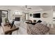 Bright living room with stone fireplace, modern decor, and plush seating area at 6170 Wellington Ct, Cumming, GA 30040