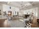 Large living room with hardwood floors, high ceilings, and an open layout leading to the kitchen at 6170 Wellington Ct, Cumming, GA 30040