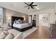 Open main bedroom boasts a large bed with a decorative wall, and hardwood floors at 6170 Wellington Ct, Cumming, GA 30040