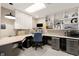 Bright office featuring custom built-in shelving and desk with gray cabinets and ample storage space at 6170 Wellington Ct, Cumming, GA 30040