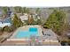 Large community pool with a bathhouse, lounge area, and ample parking at 6170 Wellington Ct, Cumming, GA 30040