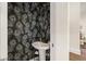 Stylish powder room featuring peacock wallpaper, a pedestal sink, and elegant fixtures at 6170 Wellington Ct, Cumming, GA 30040
