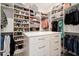 Well-organized walk-in closet has custom shelving, drawers, and center island at 6170 Wellington Ct, Cumming, GA 30040