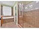 Bathroom featuring tile shower, tile flooring, and a window for natural light at 123 Patrick Way, Marietta, GA 30064