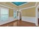 This dining room boasts hardwood floors and a tray ceiling, with a chandelier at 123 Patrick Way, Marietta, GA 30064