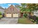 Charming stone home with a two-car garage, covered porch, and beautiful landscaping at 123 Patrick Way, Marietta, GA 30064