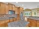Gourmet kitchen with an island, stainless steel appliances, and views to a breakfast area at 123 Patrick Way, Marietta, GA 30064