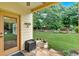 Covered patio with stone floor overlooking a lush backyard with mature trees at 123 Patrick Way, Marietta, GA 30064