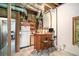 Basement bar area with wooden counter, stools, and vintage refrigerator at 1706 Remington Rd, Atlanta, GA 30341