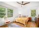 Cozy bedroom with hardwood floors, a ceiling fan, and natural light from the large windows at 1706 Remington Rd, Atlanta, GA 30341
