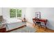 Guest bedroom featuring a decorative desk, ample light, and hardwood floors at 1706 Remington Rd, Atlanta, GA 30341