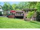 Rear exterior view of a brick home featuring a deck and landscaped yard at 1706 Remington Rd, Atlanta, GA 30341