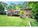 Back exterior view of the brick home with a deck, yard, and green door at 1706 Remington Rd, Atlanta, GA 30341