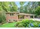 Charming brick home with a well-manicured front yard featuring lush greenery and colorful hydrangea bushes at 1706 Remington Rd, Atlanta, GA 30341