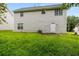 Spacious backyard with a partially overgrown lawn and a door providing access to the home's interior at 3599 Salem Glen Rd, Lithonia, GA 30038