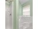 Bathroom featuring a tub with tiled walls, shower, and a window that provides natural light at 3599 Salem Glen Rd, Lithonia, GA 30038