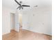 This bedroom features wood-look flooring, a ceiling fan, white walls, and a walk-in closet at 3599 Salem Glen Rd, Lithonia, GA 30038