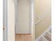 Hallway with doorways and staircase, featuring neutral wall colors and wood-look flooring at 3599 Salem Glen Rd, Lithonia, GA 30038