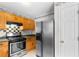 Kitchen featuring wood cabinets, stainless steel appliances, and checkered backsplash at 3599 Salem Glen Rd, Lithonia, GA 30038