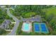 Aerial view of the community pool, tennis courts, parking and clubhouse at 7190 Tributary Ct, Cumming, GA 30040