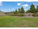 Backyard featuring a well-maintained lawn and mature landscaping at 7190 Tributary Ct, Cumming, GA 30040