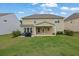 Backyard featuring a well-maintained lawn, a patio area, and mature trees at 7190 Tributary Ct, Cumming, GA 30040