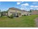 Grassy backyard featuring a well-maintained lawn, a patio area, and mature trees at 7190 Tributary Ct, Cumming, GA 30040