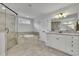 This bathroom features a large tub, walk-in shower, and granite countertops at 7190 Tributary Ct, Cumming, GA 30040