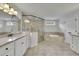 Bathroom featuring a large tub, walk-in shower, granite countertops and dual sinks at 7190 Tributary Ct, Cumming, GA 30040