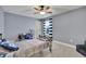 Cozy bedroom with gray walls, carpeted floors, ceiling fan, and a blue and white striped curtain at 7190 Tributary Ct, Cumming, GA 30040