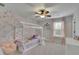 Bright bedroom with floral wallpaper, white canopy bed, ceiling fan, and soft pink curtains at 7190 Tributary Ct, Cumming, GA 30040