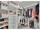 Organized walk-in closet with shelves, drawers, and hanging rods for optimal storage at 7190 Tributary Ct, Cumming, GA 30040