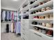 Walk-in closet with custom shelving, drawers, and racks for organized storage at 7190 Tributary Ct, Cumming, GA 30040