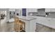 Modern kitchen with stainless steel appliances, a central island with bar seating, and sleek gray backsplash at 7190 Tributary Ct, Cumming, GA 30040