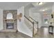 Elegant living room features a fireplace and staircase, seamlessly blending cozy charm with functional design at 7190 Tributary Ct, Cumming, GA 30040