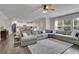 Expansive living area with a large sectional sofa and seamless flow to the kitchen, perfect for modern living at 7190 Tributary Ct, Cumming, GA 30040