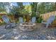 Outdoor stone fire pit with Adirondack chairs in backyard featuring a gravel bed at 755 Monticello Se Way, Marietta, GA 30067