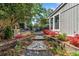 Charming backyard with stone pathway, lush landscaping, and flowering plants, creating a serene outdoor oasis at 755 Monticello Se Way, Marietta, GA 30067