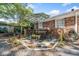 Charming backyard patio with outdoor dining set, rock landscaping, a brick house, and some greenery at 755 Monticello Se Way, Marietta, GA 30067