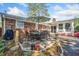 Outdoor patio area with a dining table, umbrella, flowers, and well-manicured landscaping next to the brick house at 755 Monticello Se Way, Marietta, GA 30067