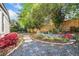 Secluded backyard featuring a stone pathway, stone planters, gravel bed and colorful flowering shrubs at 755 Monticello Se Way, Marietta, GA 30067