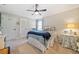 Bright bedroom with a ceiling fan, a bed with blue accents, and a door leading to more of the house at 755 Monticello Se Way, Marietta, GA 30067