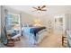 Cozy bedroom with a blue and white color scheme, rocking chair, and a glimpse into an organized closet at 755 Monticello Se Way, Marietta, GA 30067